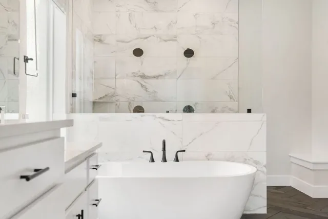 a bathroom with a bathtub and a sink