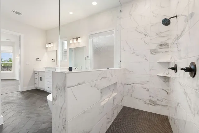 a bathroom with shower sink and mirror