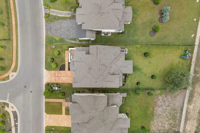 an aerial view of a house with a yard