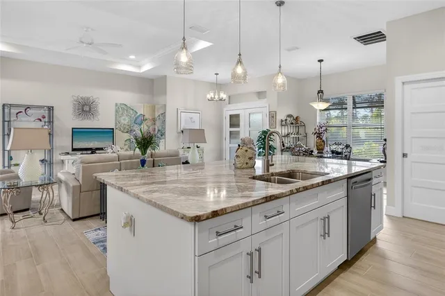 a kitchen with counter top space and living room view