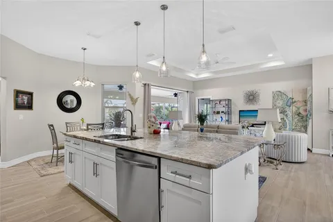 a kitchen with a stove a sink a dining table and chairs