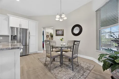 a view of a dining room with furniture and chandelier