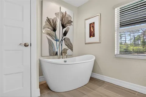 a white vase with a vase of flowers