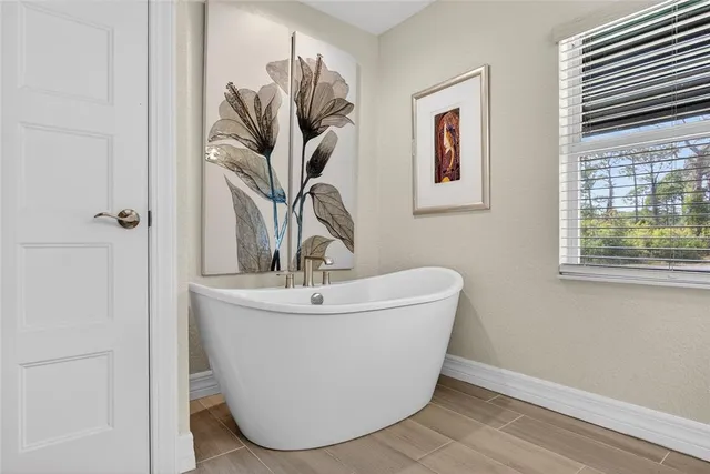 a white vase with a vase of flowers