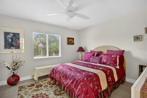 a bedroom with a bed and a potted plant