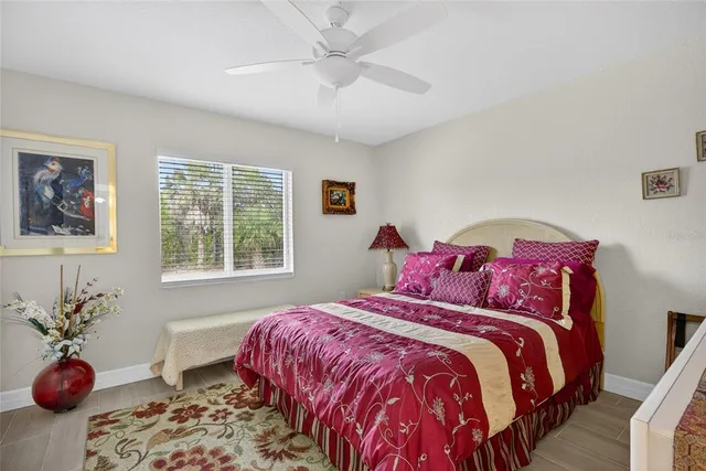 a bedroom with a bed and a potted plant