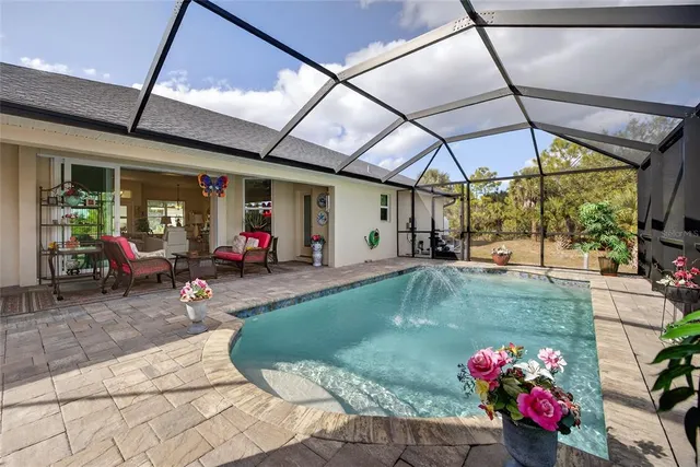 a view of a swimming pool with sitting area