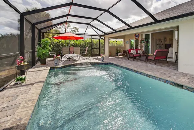 a view of a patio with table and chairs under an umbrella