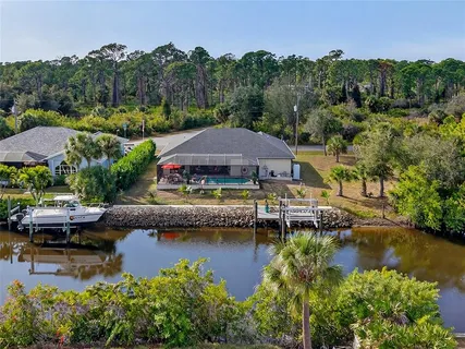 an aerial view of a house with swimming pool outdoor seating and yard