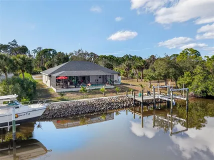 a swimming pool with outdoor seating and yard
