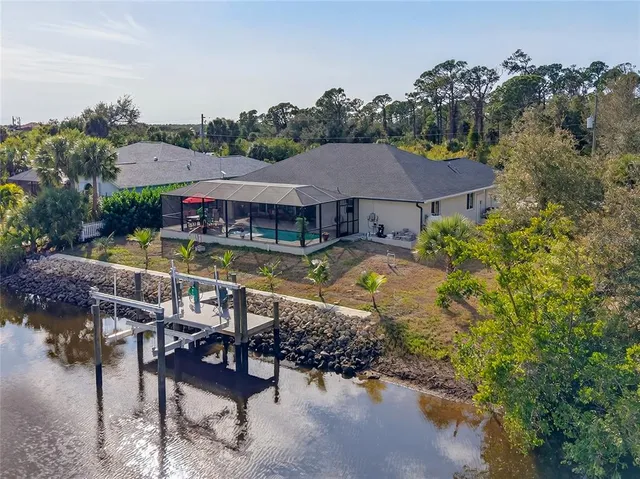 a swimming pool with outdoor seating and yard
