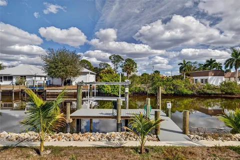 a view of a lake with a table and chairs