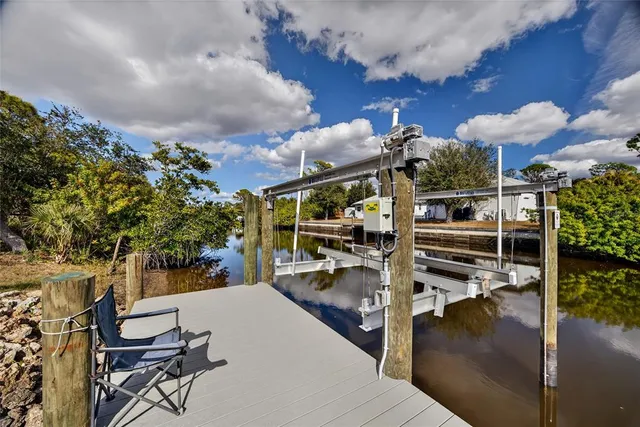 a view of a patio with table and chairs potted plants with wooden floor