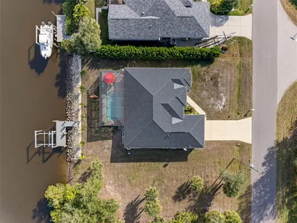 an aerial view of a house with a yard basket ball court and outdoor seating