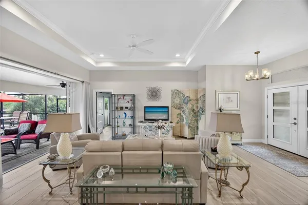 a living room with furniture and a chandelier