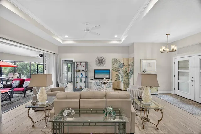 a living room with furniture and a chandelier
