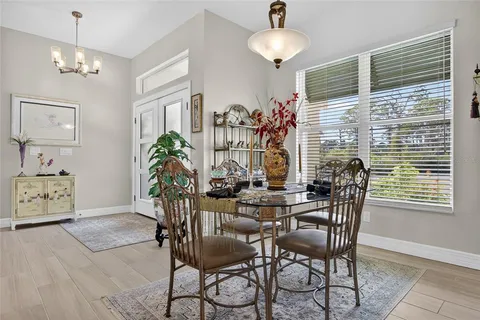 a view of a dining room with furniture and chandelier