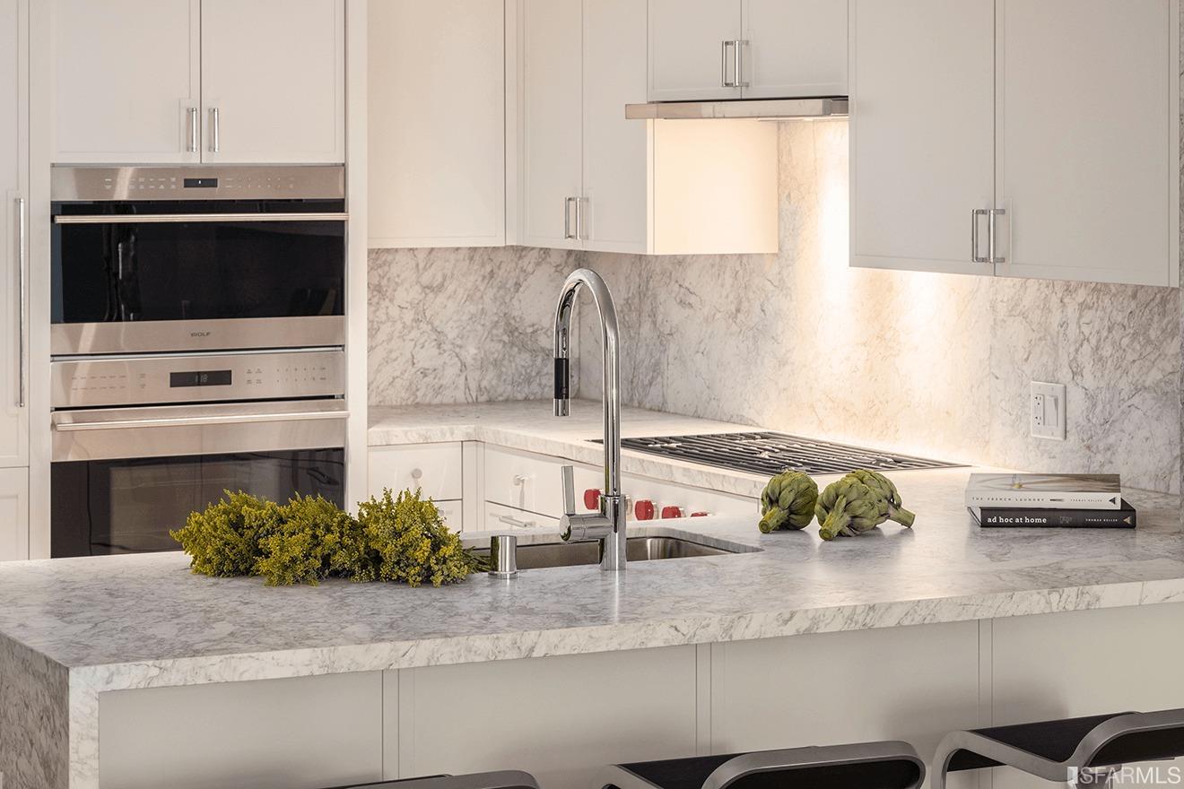 875 California Street, Unit 205 San Francisco, CA 94108 - Photo 1 of 15 a kitchen with stainless steel appliances kitchen island granite countertop a sink and a stove