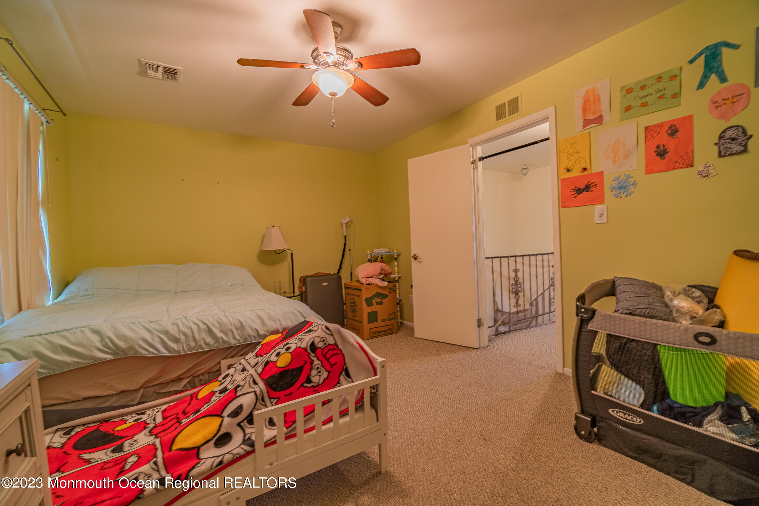 60 County Road, Unit F29 Cliffwood, NJ 07721 - Photo 15 of 26 a bedroom with a bed and a chandelier