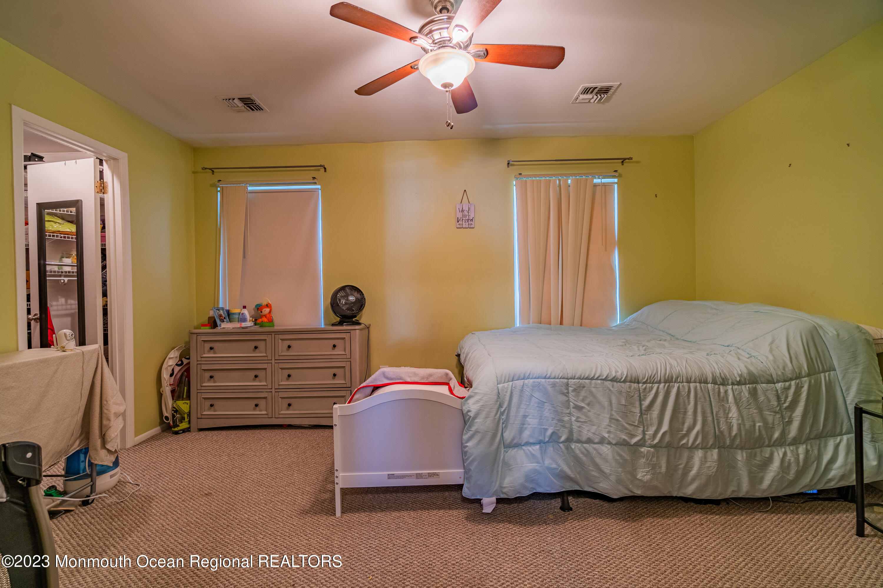 60 County Road, Unit F29 Cliffwood, NJ 07721 - Photo 16 of 26 a bedroom with a bed and a chandelier
