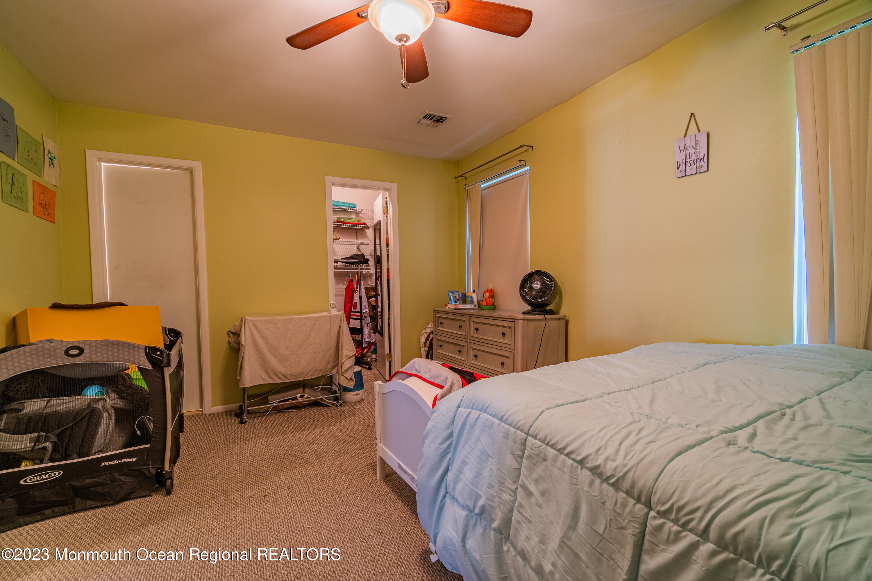 60 County Road, Unit F29 Cliffwood, NJ 07721 - Photo 17 of 26 a bedroom with a bed and a chandelier