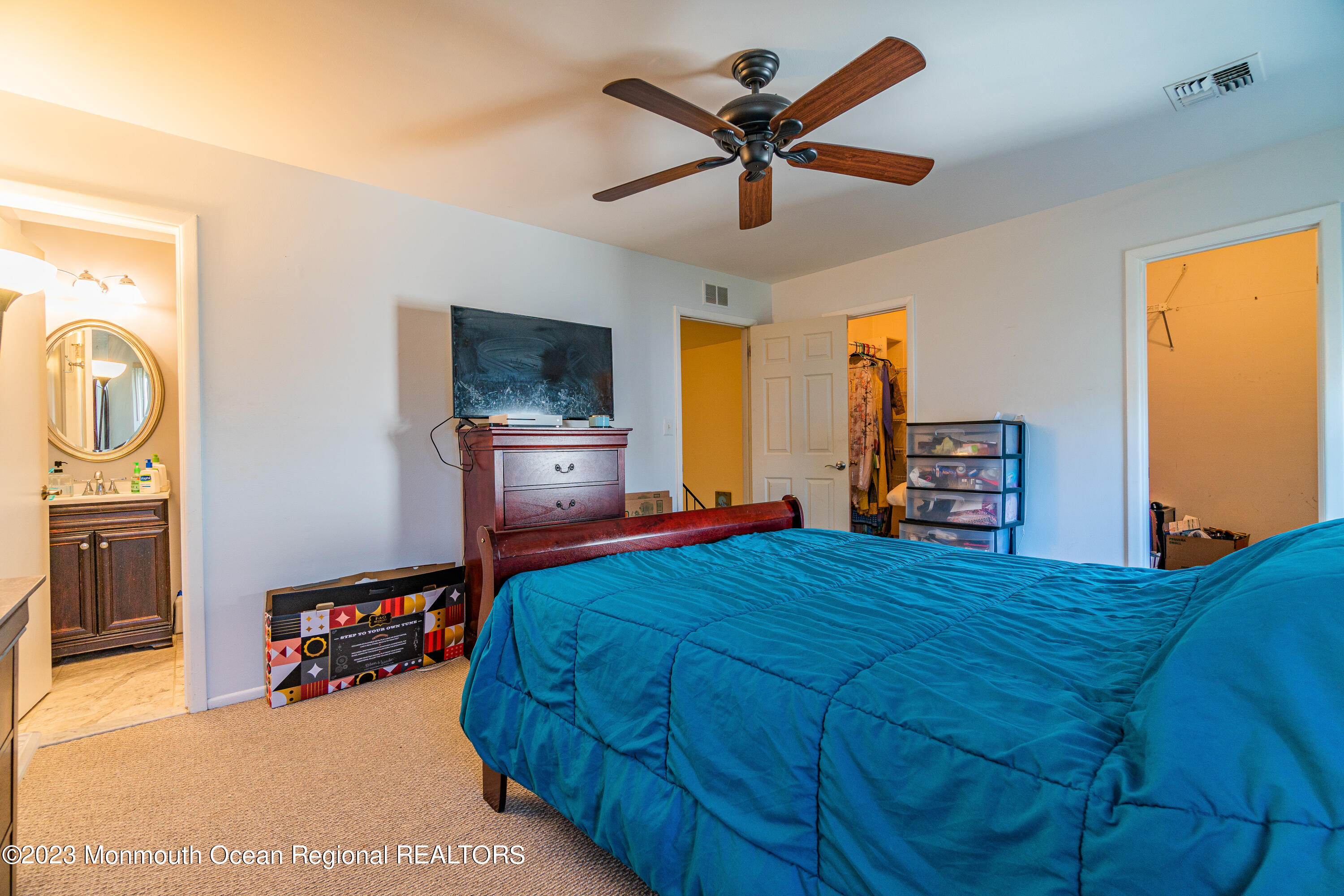 60 County Road, Unit F29 Cliffwood, NJ 07721 - Photo 19 of 26 a bedroom with a bed a dresser and flat screen tv