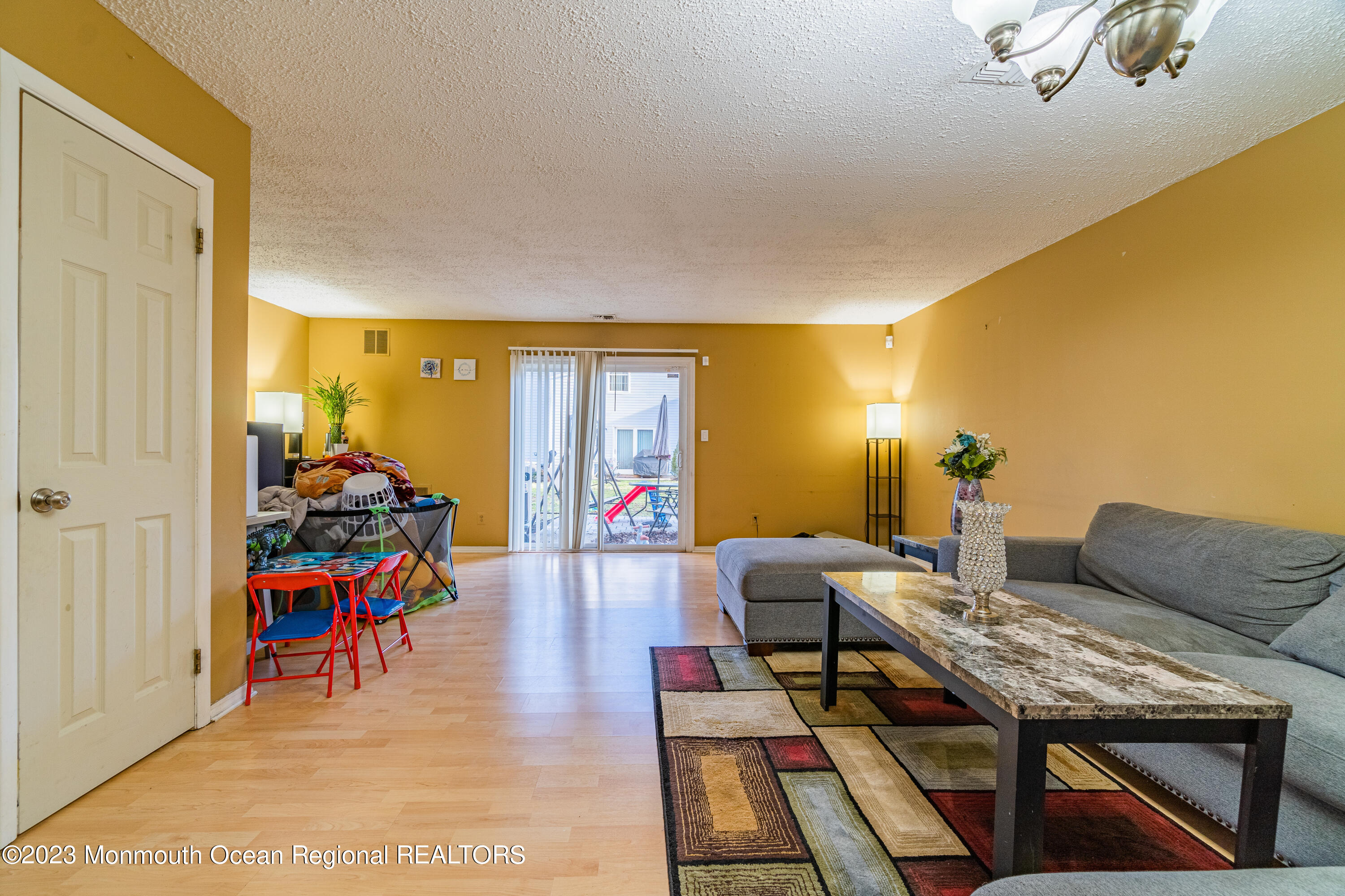60 County Road, Unit F29 Cliffwood, NJ 07721 - Photo 9 of 26 a living room with furniture a rug and a flat screen tv