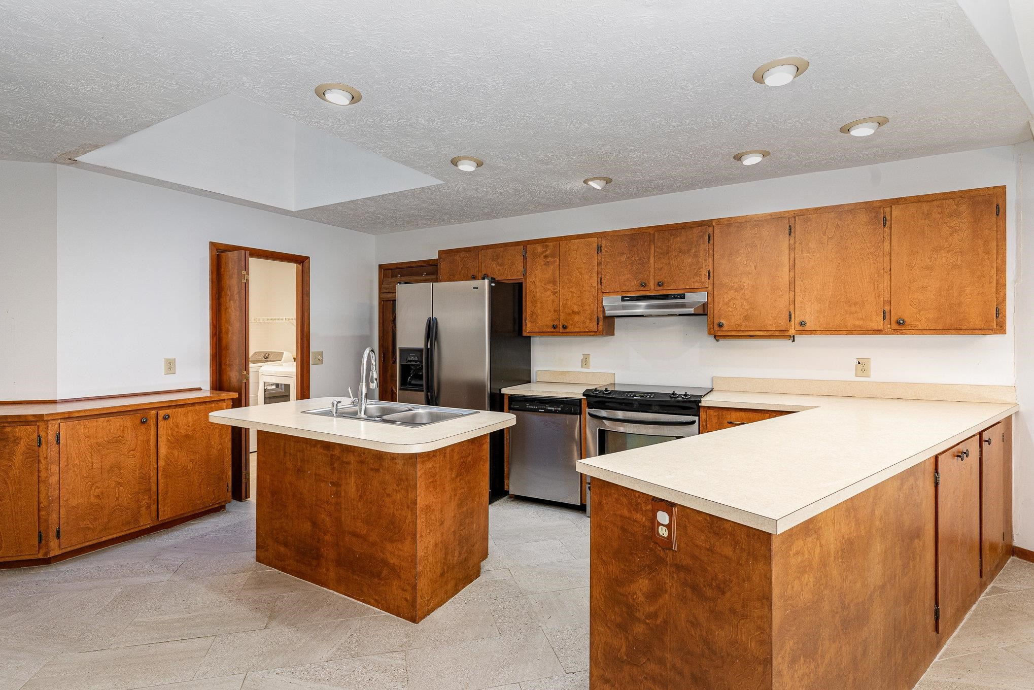 513 Argyll Drive Sanford, NC 27332 - Photo 8 of 31 a kitchen with stainless steel appliances granite countertop a stove top oven a sink a refrigerator and white cabinets
