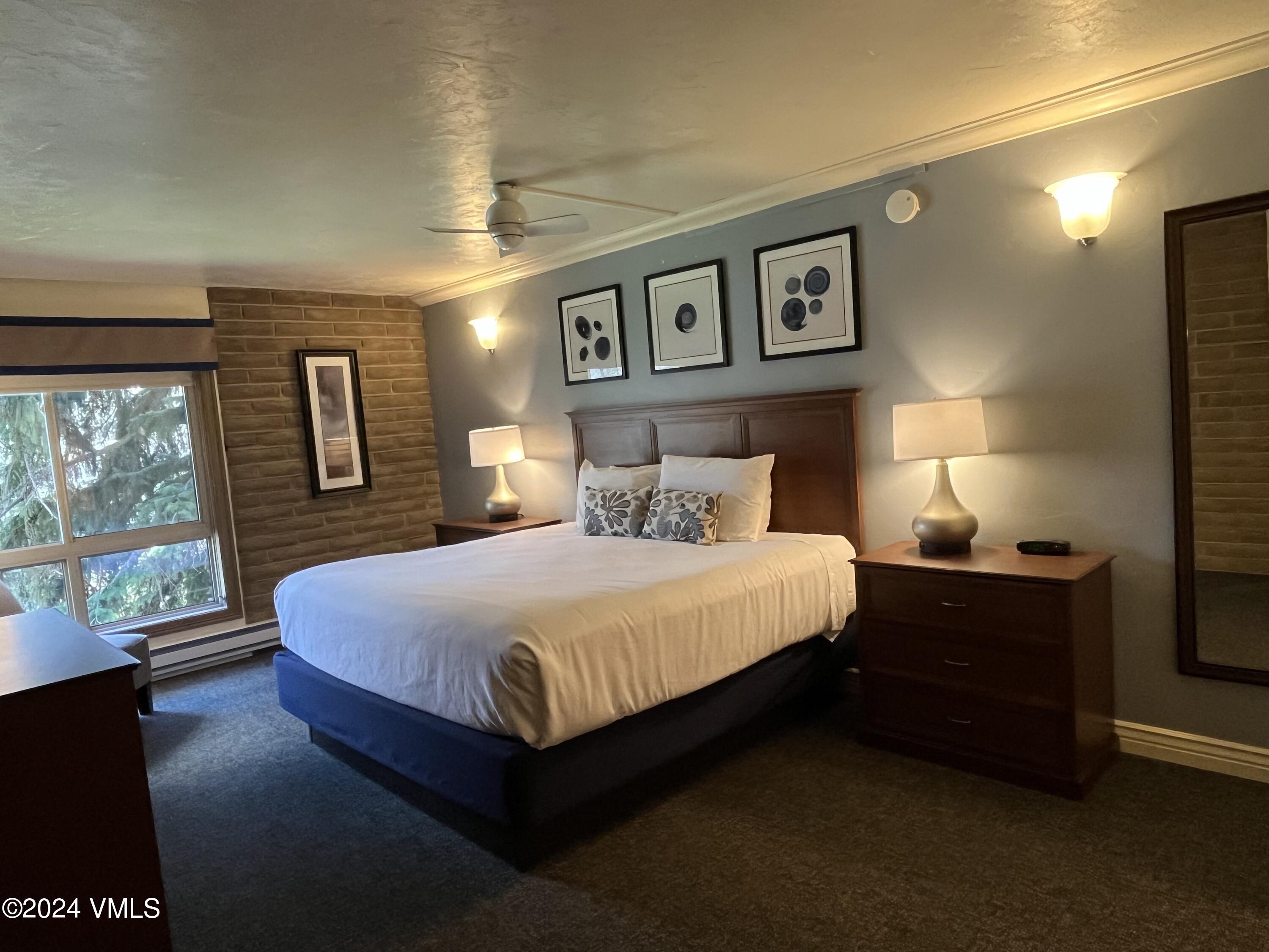 1020 Vail View Drive, Unit 131237 Vail, CO 81657 - Photo 4 of 20 a bedroom with a bed painting on wall and a large window