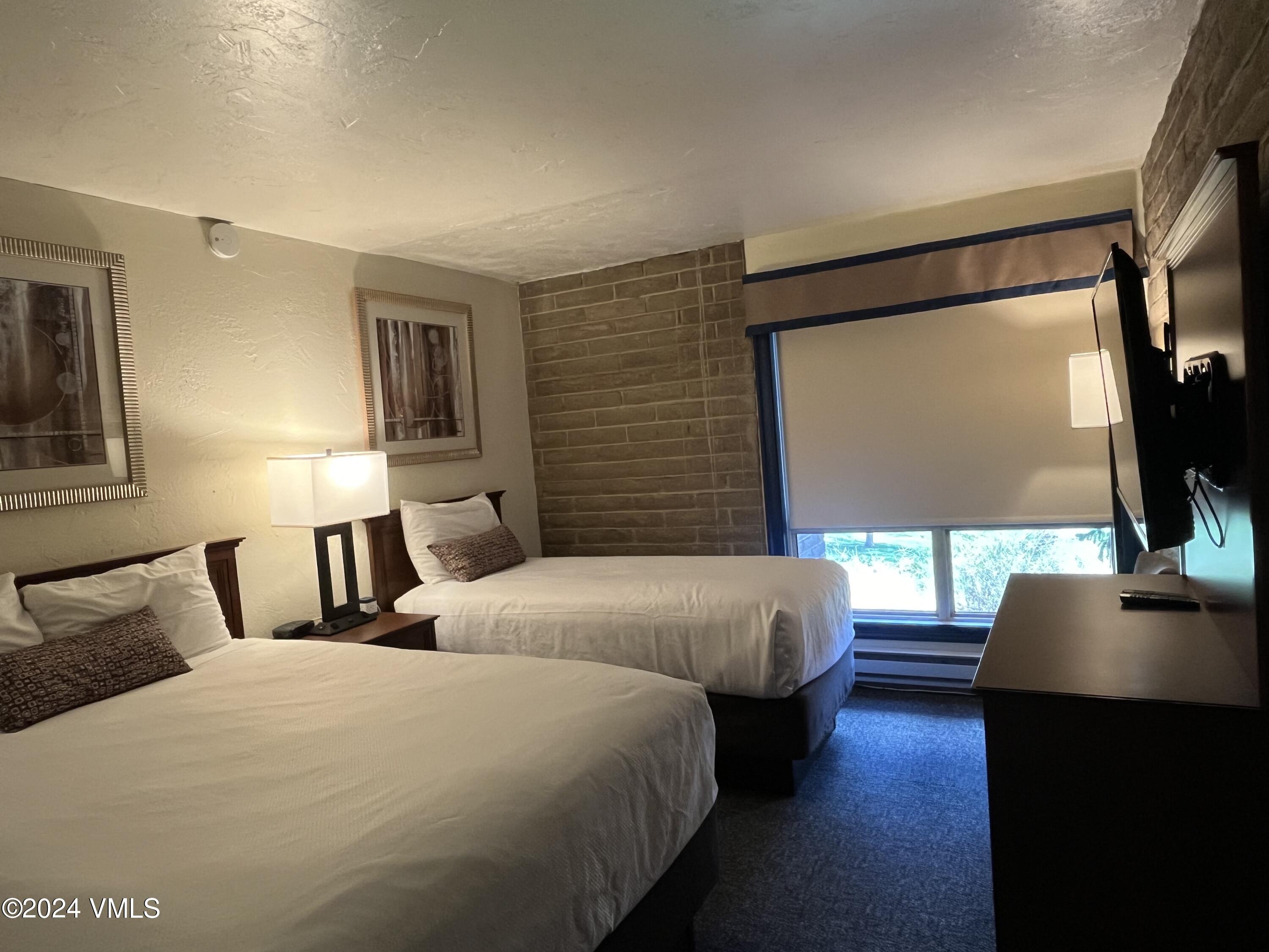 1020 Vail View Drive, Unit 131237 Vail, CO 81657 - Photo 6 of 20 a bedroom with a bed and a flat screen tv