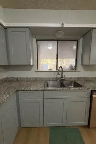 a kitchen with a sink and cabinets