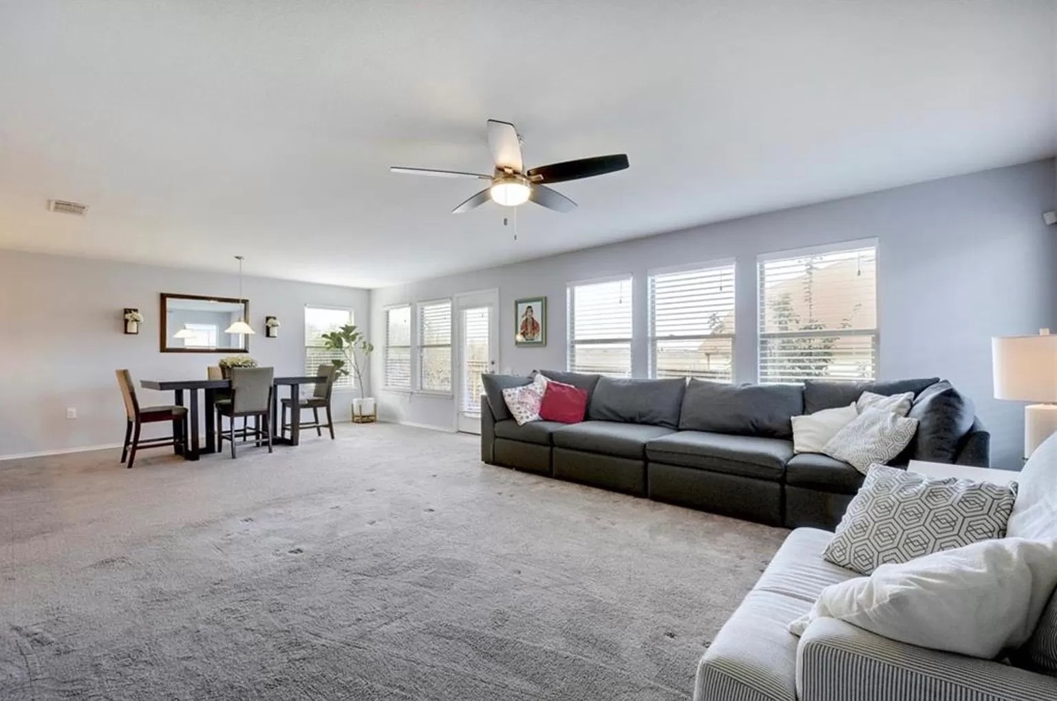 9016 Ridgewell Road Austin, TX 78747 - Photo 12 of 30 An open-concept living and dining area features abundant natural light and a comforting atmosphere.
