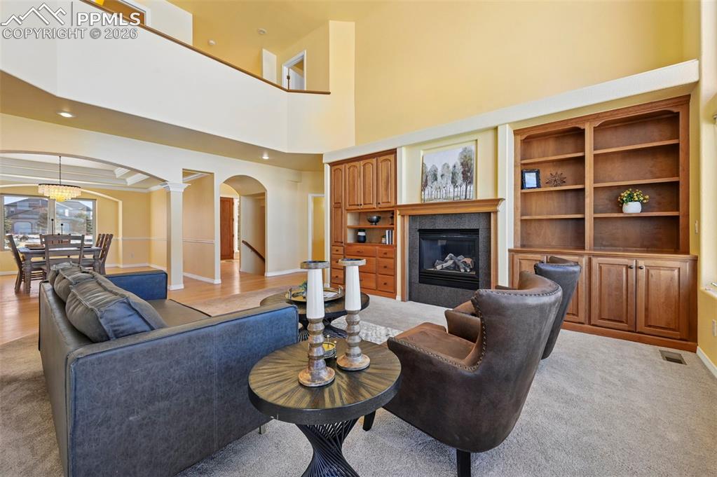 19610 Rathbone Circle Monument, CO 80132 - Photo 6 of 41 a living room with furniture kitchen view and a fireplace