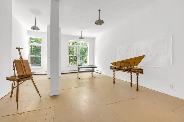 a view of a livingroom with furniture and a window