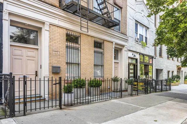 front view of a brick house with a large window