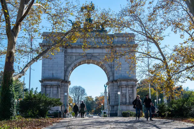 a front view of a house with a tree