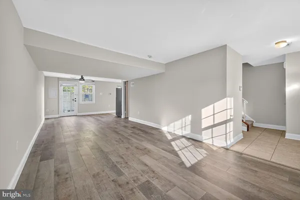 an empty space with wooden floor and windows