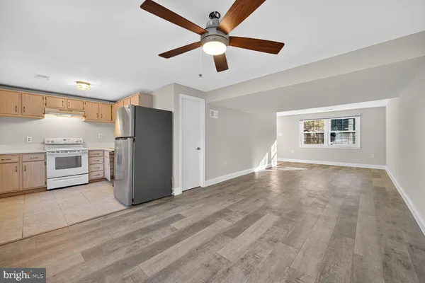 a view of a kitchen with a stove cabinets and a ceiling fan