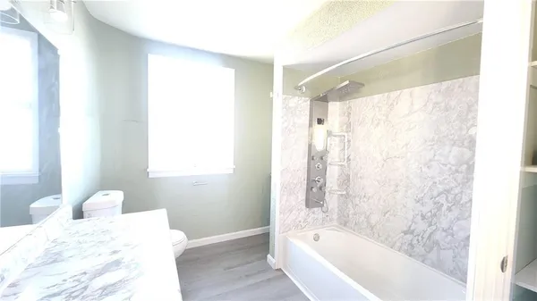 a bathroom with a bathtub and a shower