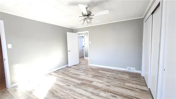 a view of a room with a ceiling fan