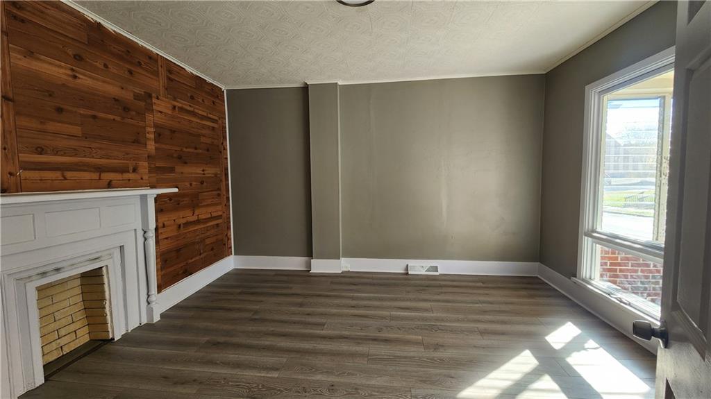 410 Longfellow Street Vandergrift, PA 15690 - Photo 2 of 25 a view of an empty room with wooden floor and a window