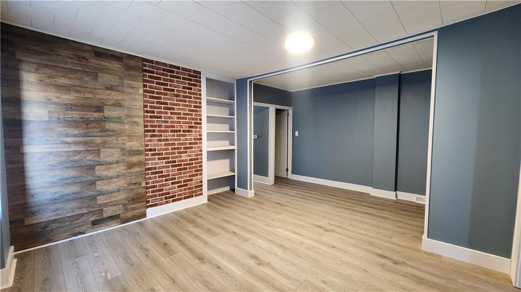 410 Longfellow Street Vandergrift, PA 15690 - Photo 7 of 25 a view of an empty room with wooden floor and a window
