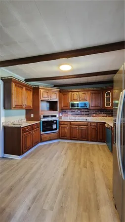 a large kitchen with stainless steel appliances and a counter top