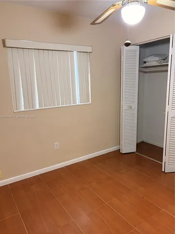 a view of an empty room with closet area