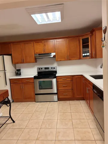 a kitchen with a stove a sink and a microwave