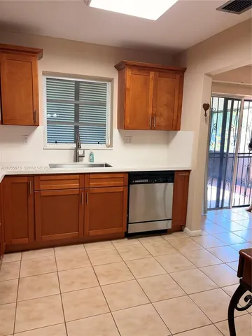a kitchen with a cabinets and wooden floor