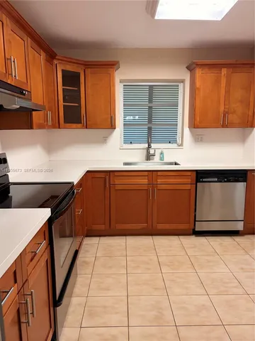a kitchen that has a sink and a stove