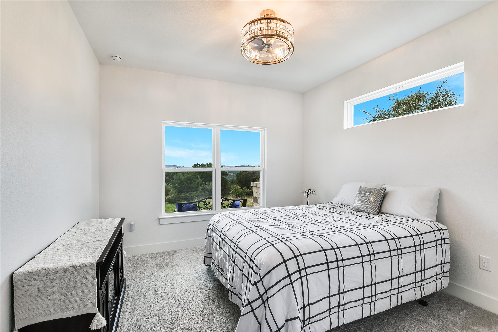 19920 Old Burnet Road Jonestown, TX 78645 - Photo 20 of 29 2nd bedroom with carpet and fan chandelier at home front