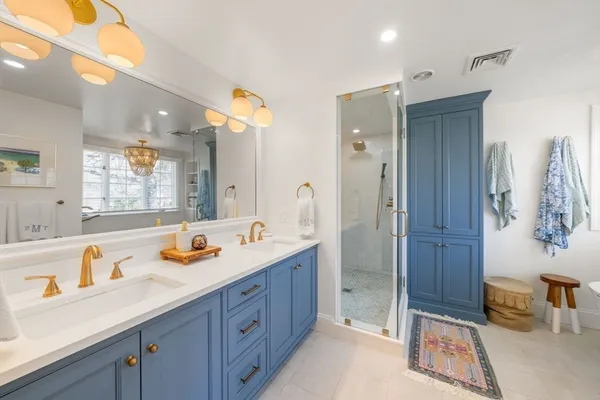 a spacious bathroom with a sink a mirror a bathtub and shower