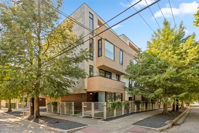 a front view of a building with trees